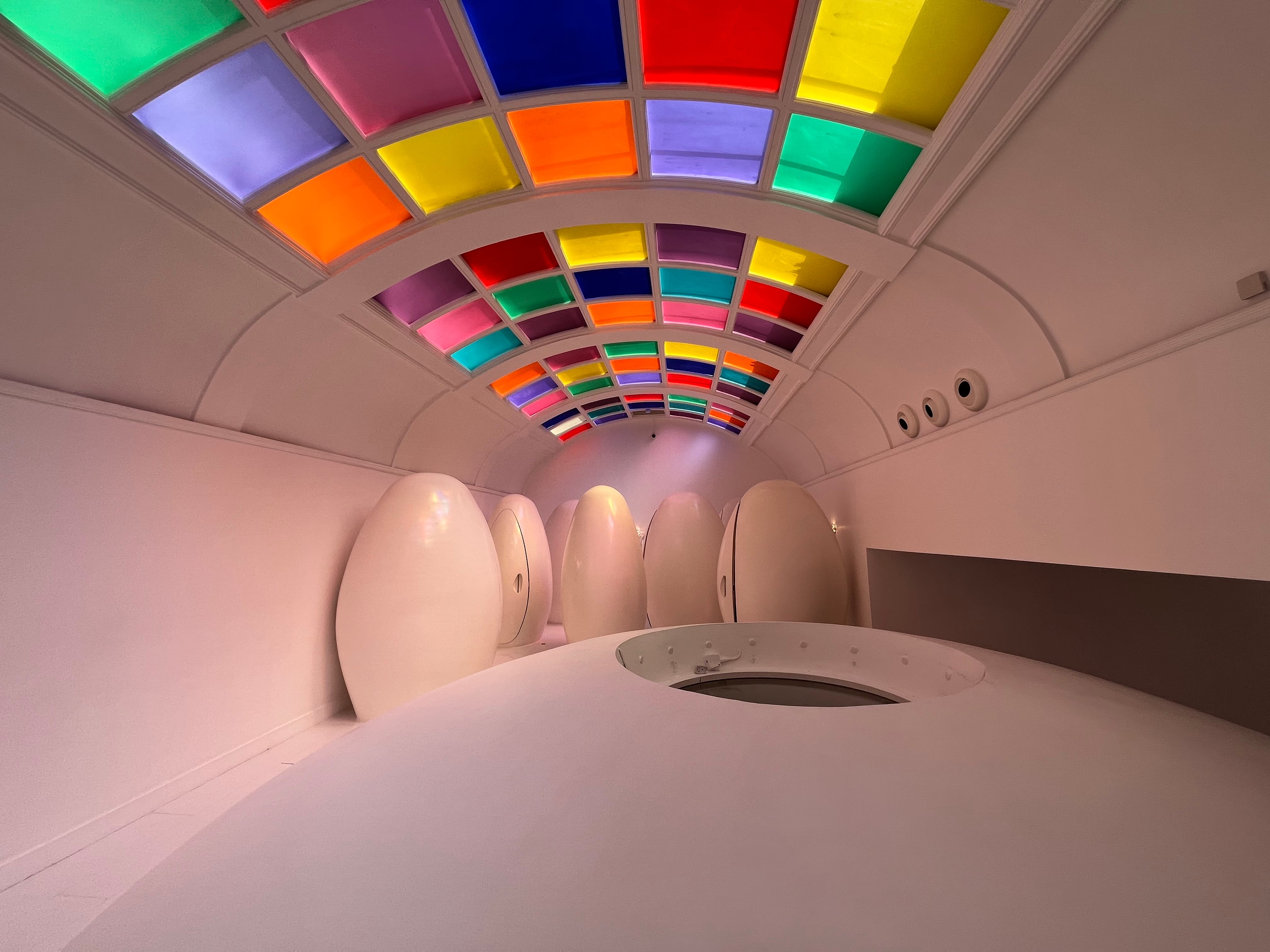 Colorful ceiling and egg-shaped toilet pods in the bathrooms at Sketch London