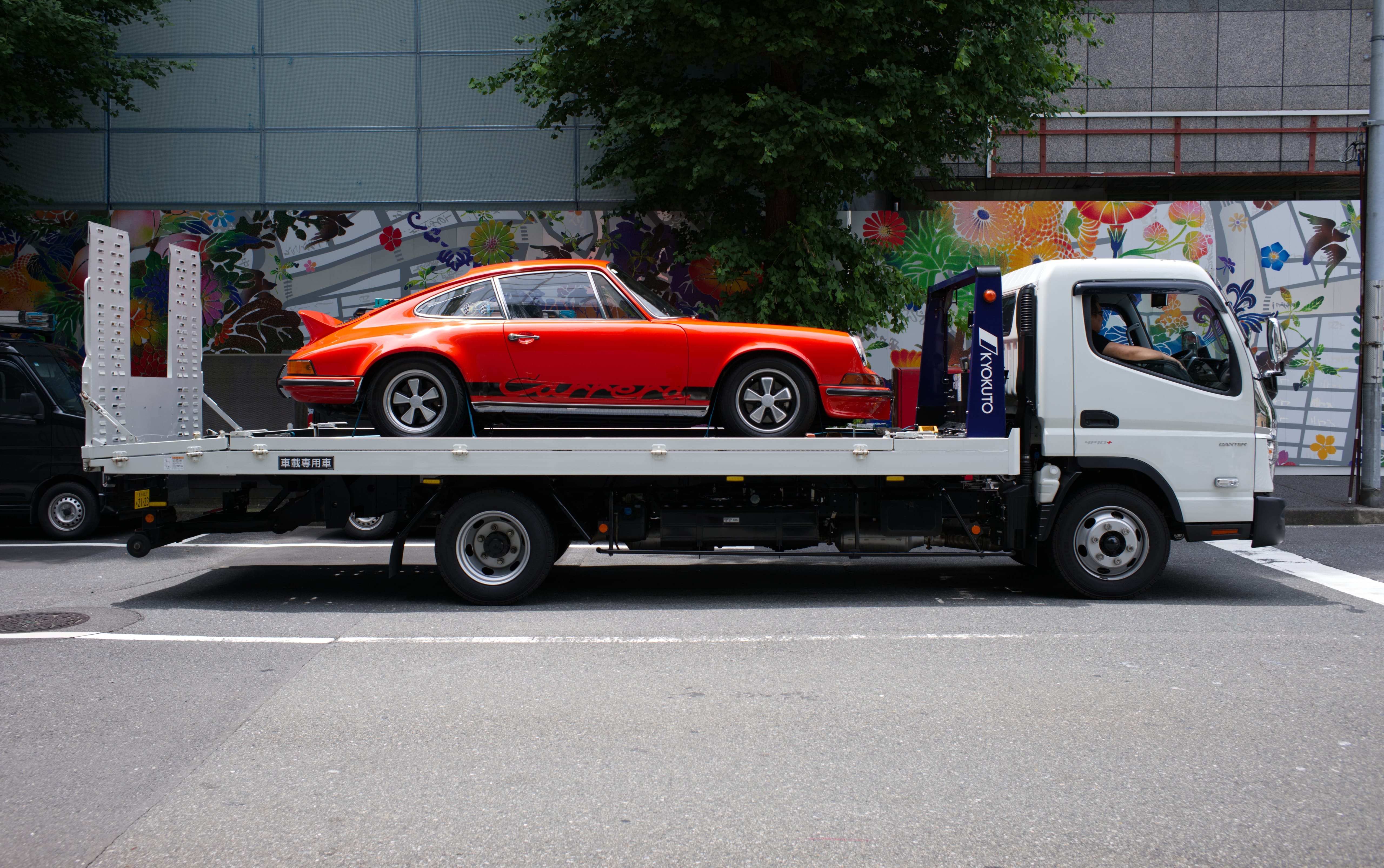 Porsche on a tow truck in Tokyo