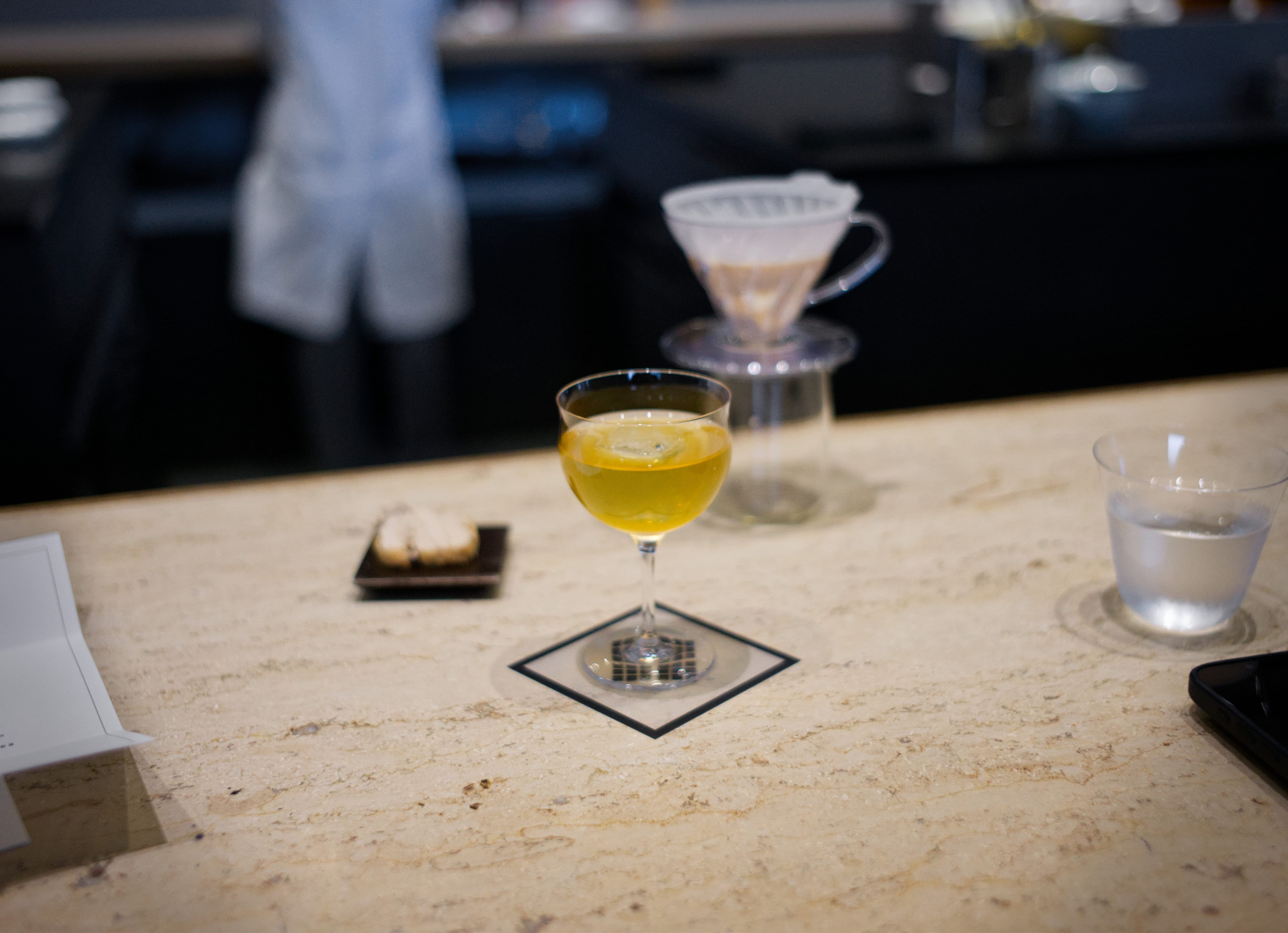 A clarified coffee milk drink in a small stemmed glass at Koffee Mameya Kakeru
