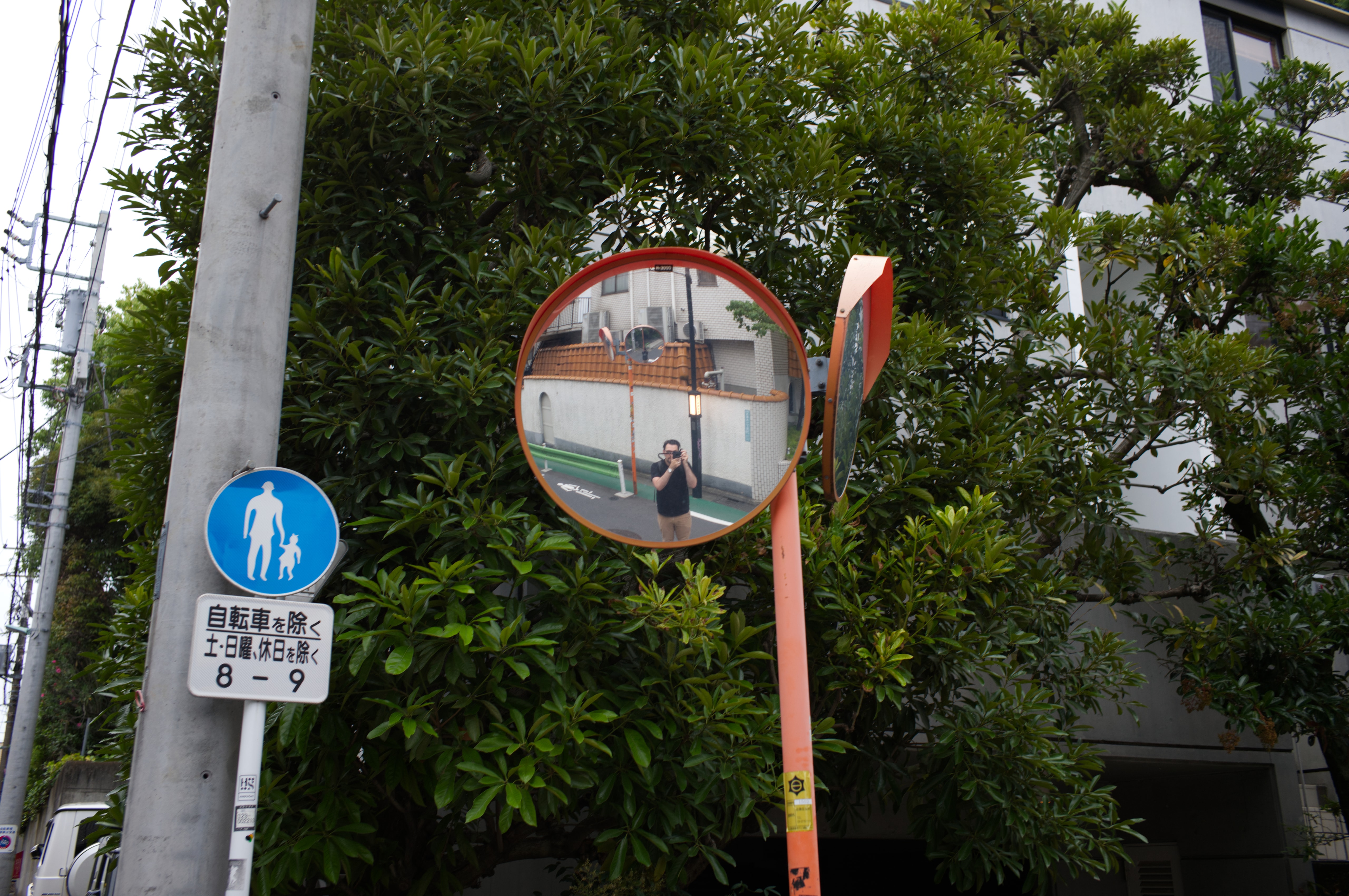 Self-portrait in a street mirror in Japan