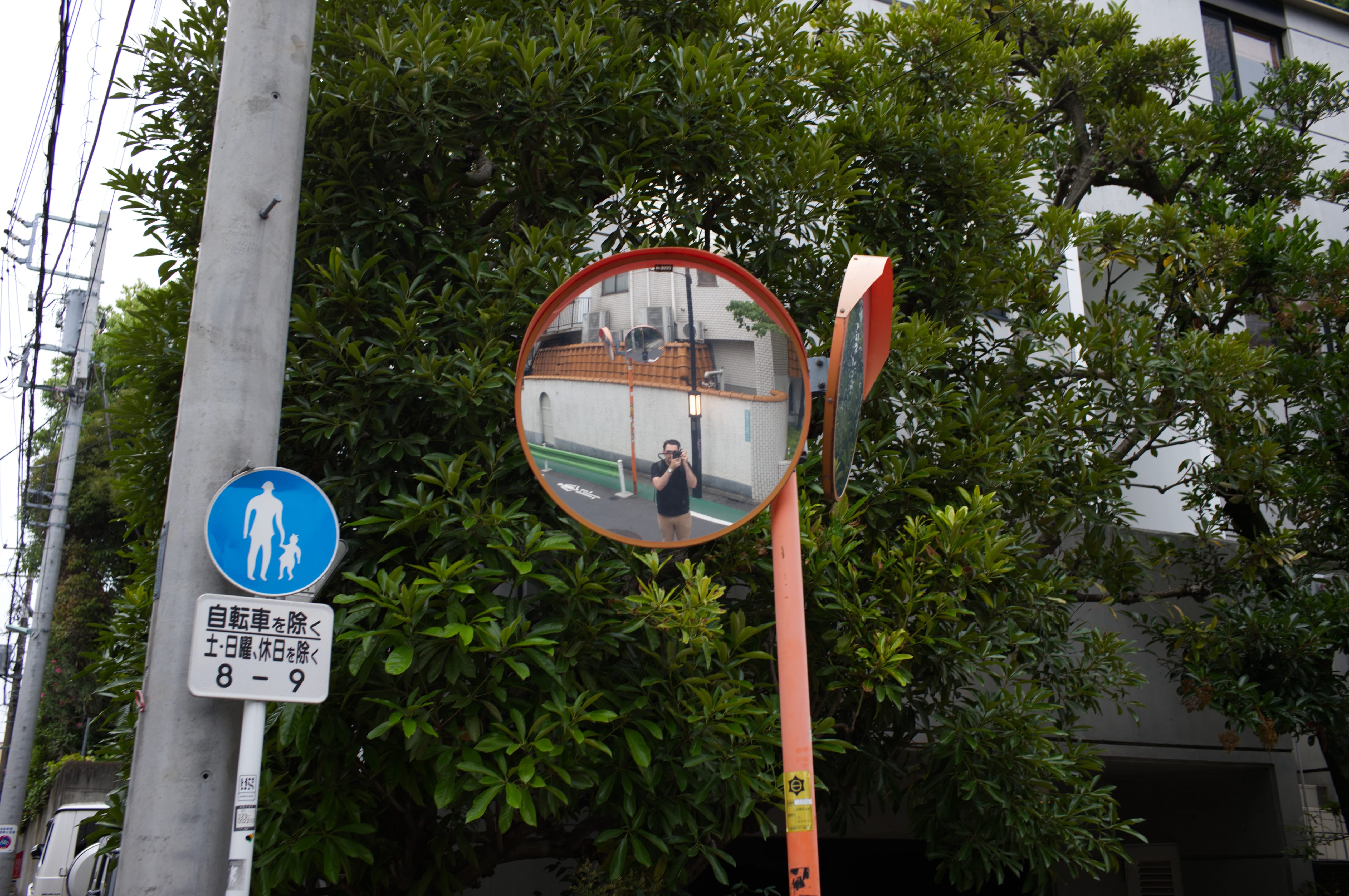 Self-portrait in a street mirror in Japan