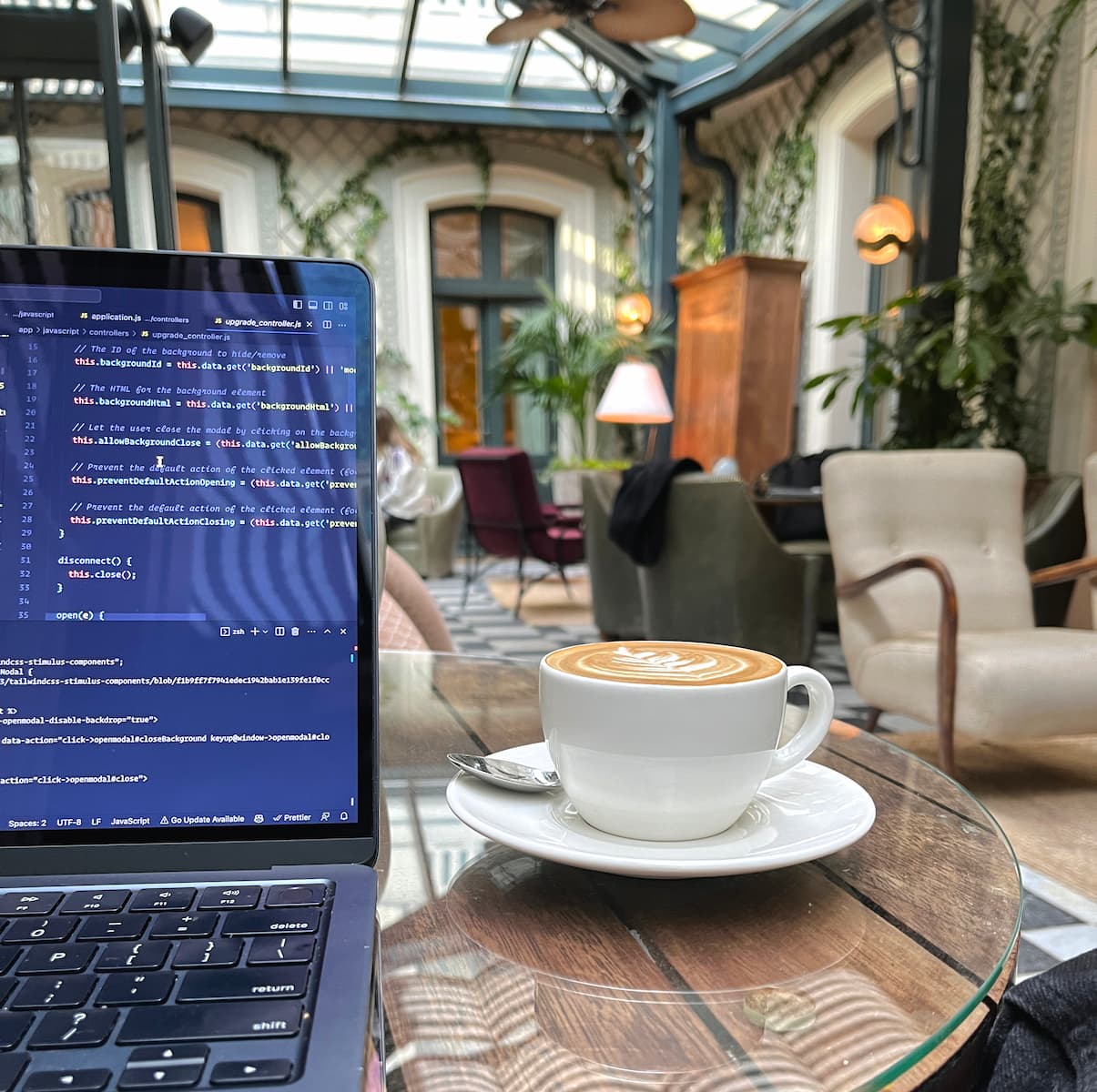 Laptop and cappuccino at Soho House Paris