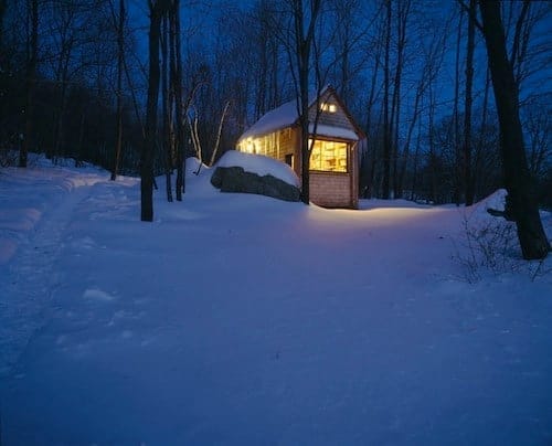 Small wooden writing cabin among trees