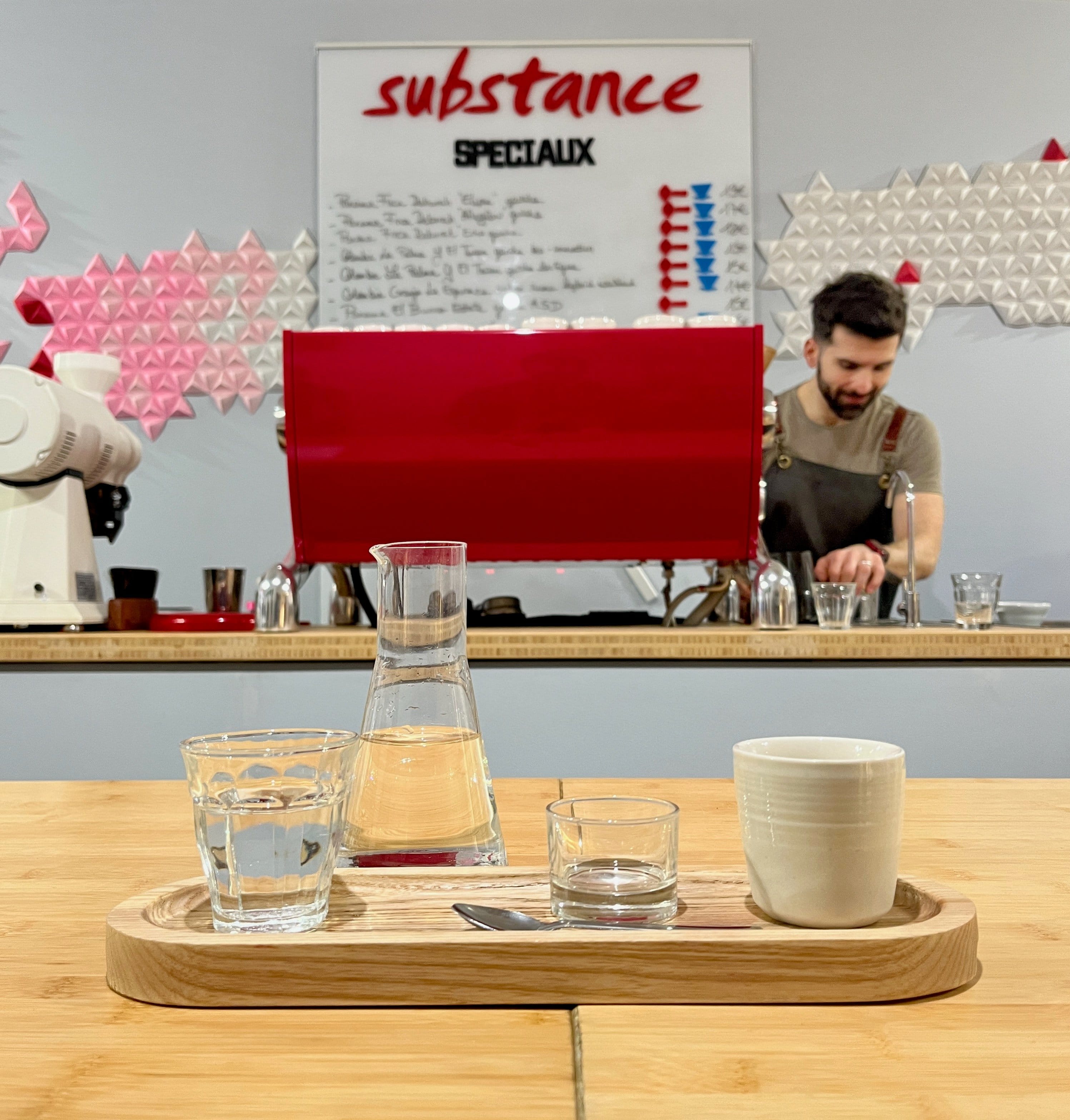 Barista behind the counter at Substance Cafe in Paris