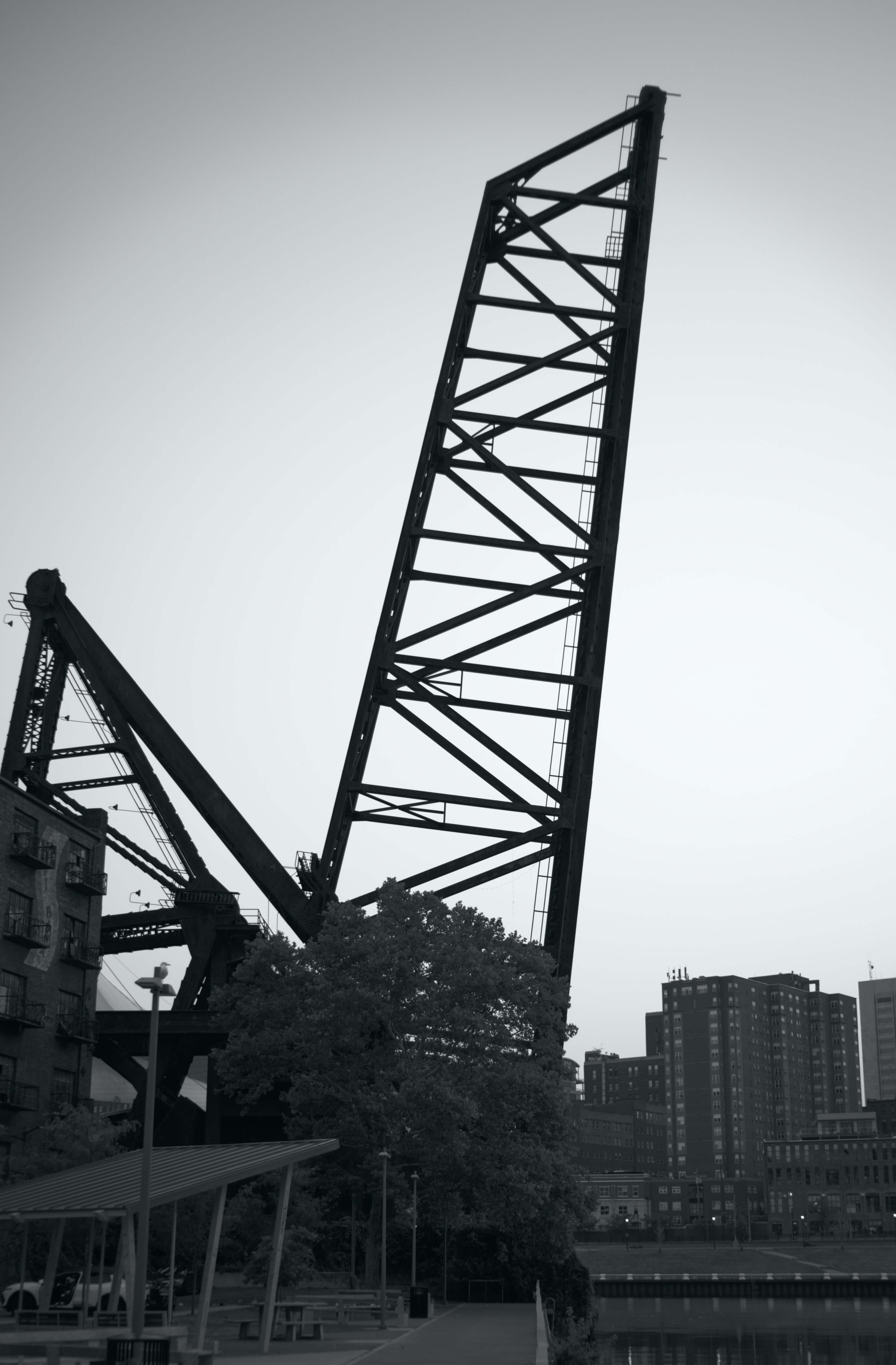 An abandoned railroad lift bridge standing upright against the sky beside the Cuyahoga River in Cleveland